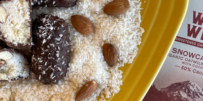 Close up image of homemade almond joy bars with coconut, almonds, and dark chocolate