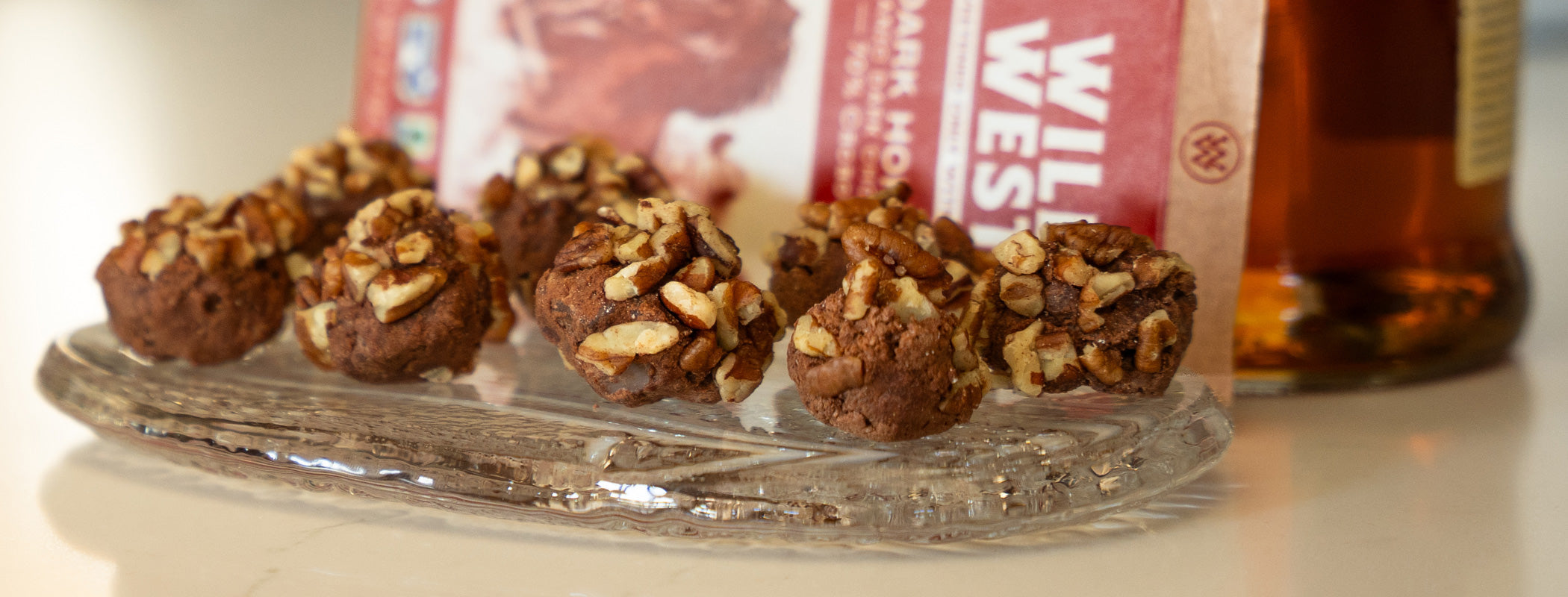 Bourbon balls arranged on a serving tray with pecans