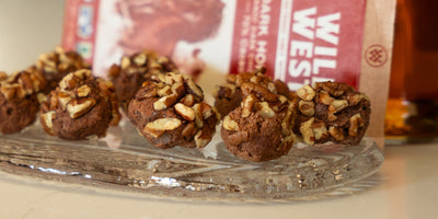 Bourbon balls arranged on a serving tray with pecans