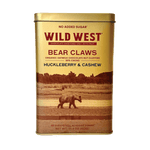 A rectangular gold metal tin of Wild West Bear Claws Chocolate Sweetened Oat Milk Chocolate Nut Clusters (Huckleberry & Cashew flavor) on a plain white background.